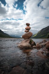 Poster - Column of rocks on the river with cliffs in the background