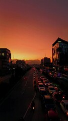 Canvas Print - Vertical shot of a dramatic sunset over the highway road with traffic