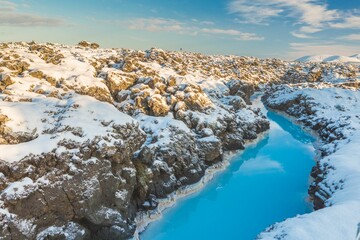 Canvas Print - Landscape of a water surrounded by snow-covered rocks