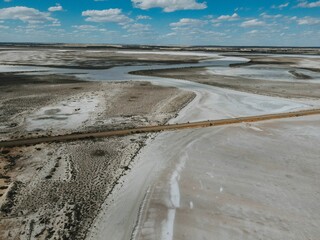 Aerial video of a dry empty field on a sunny day with unique patterns made by nature