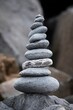 Stack of smooth stones balanced on top of a rocky surface