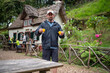 © Tessy Morelli/Stocksy - Man hiking in Madeira Island carrying Poncha drinks