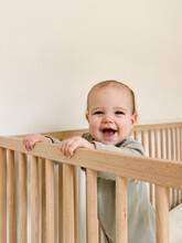 Baby Girl Smiling In Crib