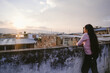 © Felipe Barrera/Stocksy - Woman leaning on rooftop wall admiring The view