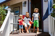 © ByLorena/Stocksy - Children at porch with superhero capes