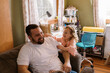 © Serena Burroughs/Stocksy - Father and daughter laughing together at home