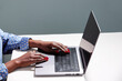 © ALTO IMAGES/Stocksy - Anonymous black woman working on project via laptop