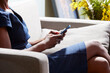 © ALTO IMAGES/Stocksy - Cropped picture of black lady texting message on mobile