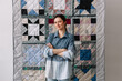 © Viktor Solomin/Stocksy - Upcycling designer presenting patchwork blanket