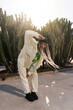 © Ezequiel Giménez/Stocksy - Stylish woman dancing near cactuses