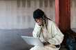 © Ezequiel Giménez/Stocksy - Woman watching funny video on laptop in loft