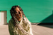 © Ezequiel Giménez/Stocksy - Dreamy woman with braids and closed eyes on street