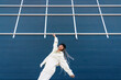 © Ezequiel Giménez/Stocksy - Stylish woman performing hip hop dance against blue wall