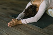 © Mihajlo Ckovric/Stocksy - Adult woman doing yoga in yoga studio