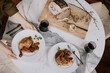 © Jarusha Brown/Stocksy - Dinner for two on a marble table in a cabin.