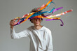 © Danil Nevsky/Stocksy - Young LGBT activist holding multicolored ribbons