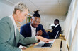 © Bruce and Rebecca Meissner/Stocksy - Colleagues working together in an office space