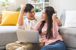 © KMPZZZ - Happy excited, smiling asian young couple love using laptop computer, great deal or business success, received or getting cash back, tax refund, good news by mail while sitting in living room at home.