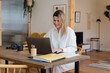 © Nuria Seguí/Stocksy - Smiling Entrepreneur Woman In Home Office