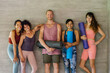 © Mihajlo Ckovric/Stocksy - Portrait of group of happy people at yoga class