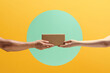 © Marc Tran/Stocksy - Delivery service. Two people hands handing the delivered