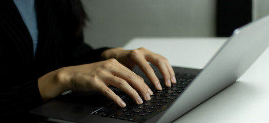 Poster - Businesswoman using laptop notebook computer. business technology background.