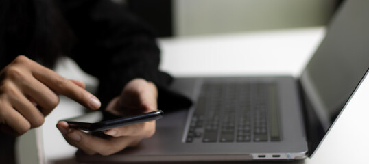 Fototapete - Close up using smartphone and laptop computer with blank screen . Tachnology and business concept