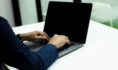 Fototapete - Businessman using laptop notebook computer, black blank screen for advertising text. Technology and business.