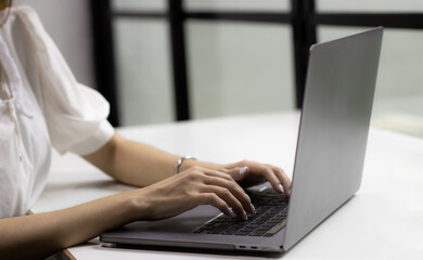 Poster - Woman using laptop computer working at home. Technology and business concept.