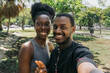 © Daniel Zapata/Stocksy - Friends in the park taking a selfie.