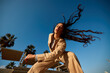 © Javier Díez/Stocksy - Young lady listening to song and dancing in park