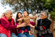 © Erin Brant/Stocksy - Happy and smiling multi generational asian family outdoors in yard