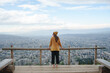 © EASY 2 SHOOT/Stocksy - Young woman in the park looking over the city