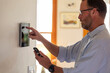 © Raymond Forbes LLC/Stocksy - Smart Home technology Panel adjustment  in Home