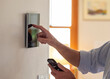 © Raymond Forbes LLC/Stocksy - Smart Home technology Panel in Home with Mobile phone