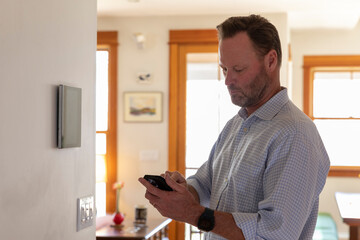 Smart Home technology Panel in Home interior with man 