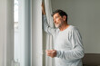 © Studio Firma/Stocksy - Senior Man Looking Through Window