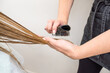 © Alvaro Lavin/Stocksy - hairdresser brushing and combing client's hair in a hairdressing salon