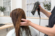 © Alvaro Lavin/Stocksy - woman hairdresser drying long wet hair in hairdresser's salon
