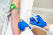 © Alvaro Lavin/Stocksy - doctor drawing blood from patient