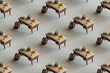 © Giada Canu/Stocksy - 3d pattern of many desks with books. education concept