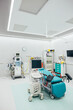© VICTOR TORRES/Stocksy - Medical equipment on rollers and cabinet in modern hospital