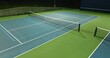 Evening video of outdoor blue tennis courts with pickleball lines with lights turned on.	
