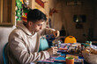 © Pedro Merino/Stocksy - Young man having breakfast in an arabic house