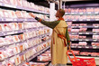 © Ivan Gener/Stocksy - Woman shopping for meat in a supermarket