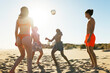 © BONNINSTUDIO/Stocksy - Happy friends playing with ball on beach