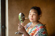 © Marc Tran/Stocksy - Beautiful young woman shaving her face by razor at home