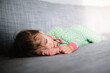 © Maria Manco/Stocksy - Toddler sleeps on couch