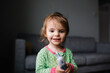© Maria Manco/Stocksy - Toddler tries to take her own temperature