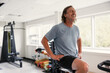 © Rob and Julia Campbell/Stocksy - Sweaty, tired, happy older man recovering after spin workout.